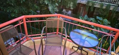 two chairs and a table on a balcony at The Palmana Tropical Garden Jayakarta Residence 38 in Seminyak