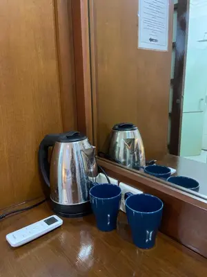 two tea pots sitting on a counter with blue cups at W Hotel at Kuta Beach By Micky Studio -1 minutes to beach in Legian