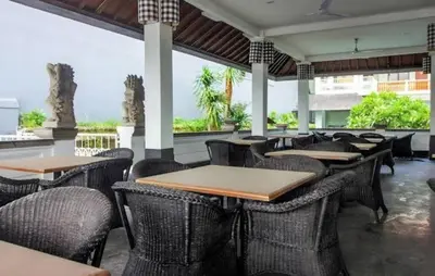 a restaurant with tables and chairs in a building at W Hotel at Kuta Beach By Micky Studio -1 minutes to beach in Legian