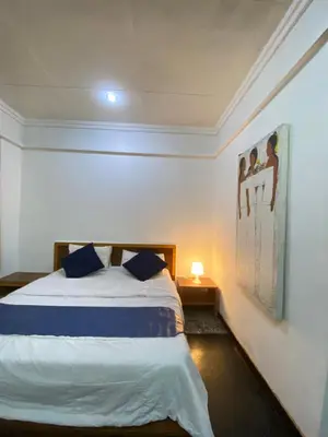 a bedroom with a bed and a painting on the wall at W Hotel at Kuta Beach By Micky Studio -1 minutes to beach in Legian