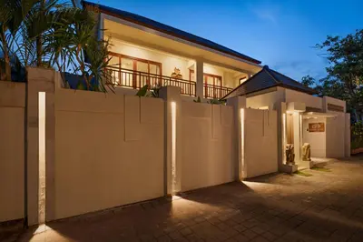 a white fence in front of a house at Levan Villa Seminyak in Seminyak