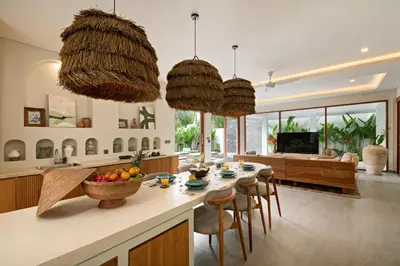 a kitchen and living room with a table and chairs at Levan Villa Seminyak in Seminyak