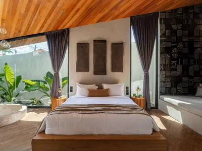 a bedroom with a large bed and a large window at House of Winds Complex - Stylish 12BR Design Estate - 4 Villas near Canggu in Kerobokan
