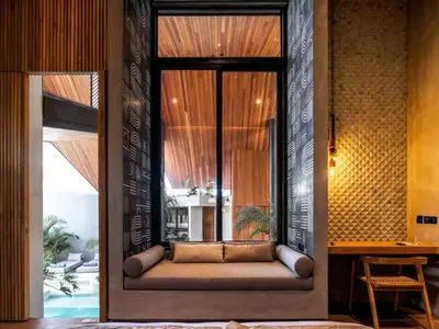 a room with a couch in the middle of a room at House of Winds Complex - Stylish 12BR Design Estate - 4 Villas near Canggu in Kerobokan