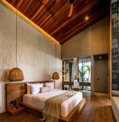 a bedroom with a large bed in a room at House of Winds Complex - Stylish 12BR Design Estate - 4 Villas near Canggu in Kerobokan