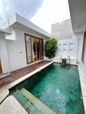 a swimming pool in the backyard of a house at Phil's Harmony Seminyak in Kerobokan