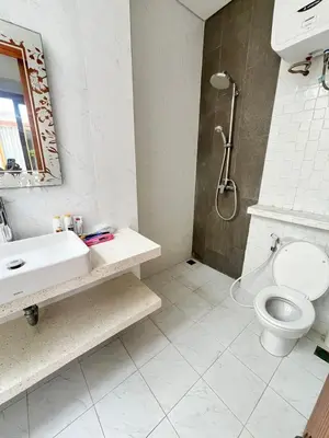 a bathroom with a toilet and a sink and a shower at Phil's Harmony Seminyak in Kerobokan