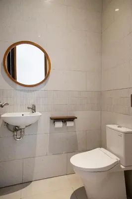 a bathroom with a toilet and a sink and a mirror at Villa Mai Mai Seminyak in Seminyak