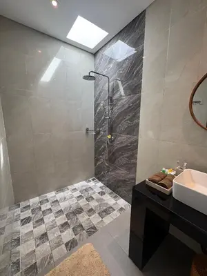 a bathroom with a shower and a sink at Villa Elysia in Canggu