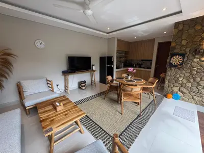 a living room with a table and a couch at Villa Elysia in Canggu