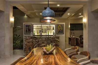 a dining room with a wooden table and chairs at The Secret Villas in Seminyak