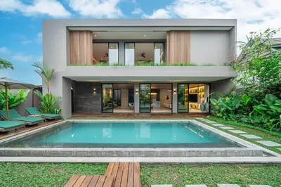 a house with a swimming pool in front of it at The Plaza 4BR With Pool in Bali s Eat Street in Seminyak