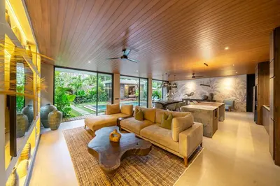 a living room with a couch and a table at The Plaza 4BR With Pool in Bali s Eat Street in Seminyak