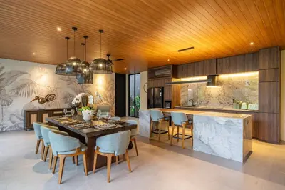a kitchen and dining room with a table and chairs at The Plaza 4BR With Pool in Bali s Eat Street in Seminyak