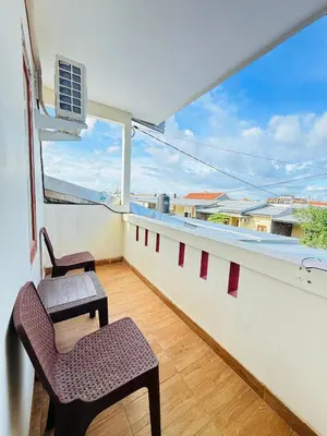a balcony with two chairs and a window at Room in Guest House near Kuta Beach Bali in Pesanggaran