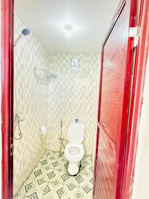 a bathroom with a toilet and a shower at Room in Guest House near Kuta Beach Bali in Pesanggaran