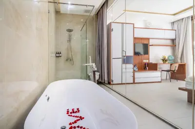 a bathroom with a tub with red writing on it at Villa Yudhistira by JB Villas in Seminyak