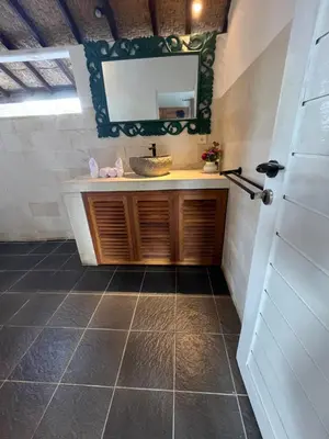 a bathroom with a sink and a mirror at New Villa Soul asa in Seminyak