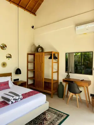 a bedroom with a bed and a desk at Villa Nelaya - Modern 3BR Retreat Private Pool Walk to the Beach in Seminyak