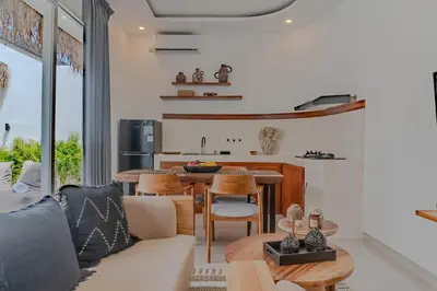 a living room with a table and a kitchen at NEW! Queen Villa - 2BR Villa in Seminyak in Seminyak