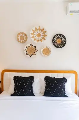 a bedroom with a bed with plates on the wall at NEW! Queen Villa - 2BR Villa in Seminyak in Seminyak