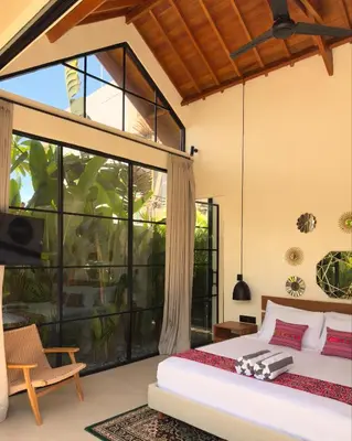 a bedroom with a bed and a large window at Villa Allany - Modern 2BR Tropical Hideaway Private Pool in Seminyak
