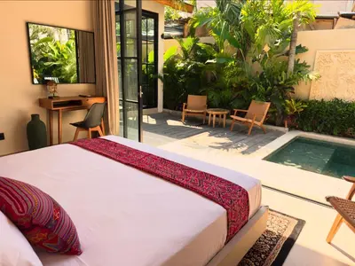 a bedroom with a bed and a swimming pool at Villa Allany - Modern 2BR Tropical Hideaway Private Pool in Seminyak