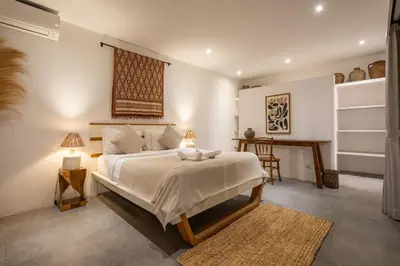 a bedroom with a large bed and a desk at Renovated Villa Zayya, Central Oberoi Seminyak in Seminyak