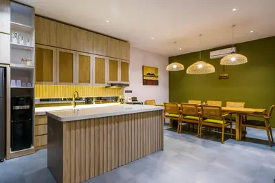 a kitchen with a table and a dining room at New 3 Bedroom Villa with rooftop central Seminyak in Seminyak