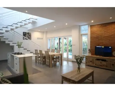 a living room with a staircase and a dining room at New 3BR Orchid Private Pool Villa Seminyak in Seminyak