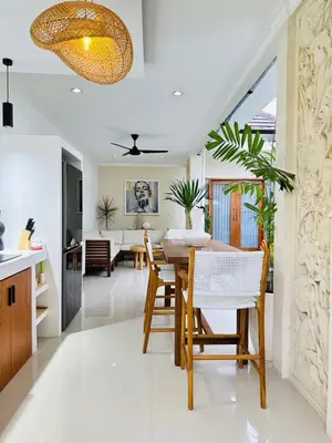 a kitchen and dining room with a table and chairs at Villa Karma Damai in Seminyak