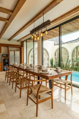 a large dining room with a long table and chairs at Tuluscoliving Villa Kuta 1, 4 Bedroom & 5 Bathroom in Ngurah Rai International Airport