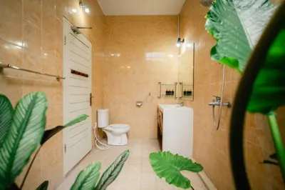 a bathroom with a toilet and a shower and a sink at Villa Nagomi in Seminyak
