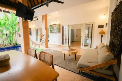 a living room with a couch and a table at Villa Nagomi in Seminyak