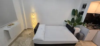 a white couch in a room with a sink at The Palmana Tropical Garden Jayakarta Residence 36 in Seminyak