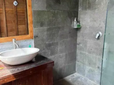 a bathroom with a white sink and a shower at Uma Padi Cabin Umalas Bali in Kerobokan