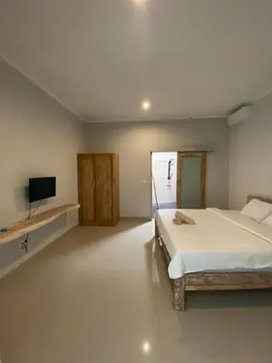 a bedroom with a bed and a flat screen tv at Two spacious bedroom villa in Seminyak