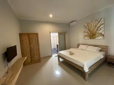 a bedroom with a bed and a flat screen tv at Two spacious bedroom villa in Seminyak