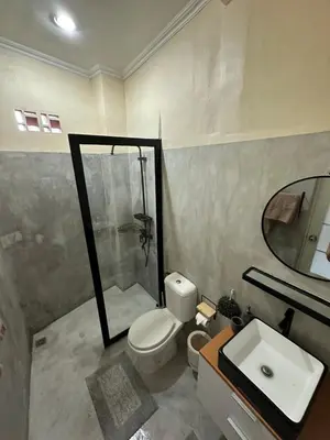 a bathroom with a toilet and a sink and a mirror at Hustlers paradise in Bali in Kerobokan