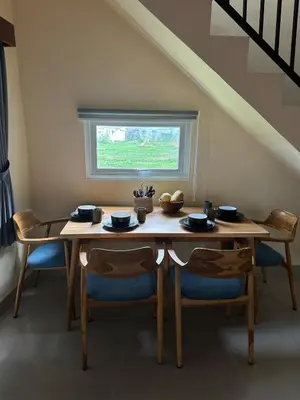 a dining room table with chairs and a window at Hustlers paradise in Bali in Kerobokan