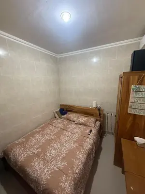 a small bedroom with a bed in a room at Hustlers paradise in Bali in Kerobokan