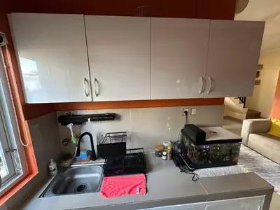a kitchen counter with a sink and a microwave at Hustlers paradise in Bali in Kerobokan