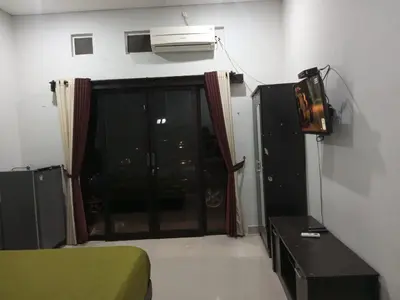 a room with a bed and a tv and a window at Room in Pesanggaran in Pesanggaran