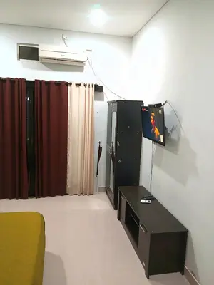 a living room with a tv and a table at Room in Pesanggaran in Pesanggaran