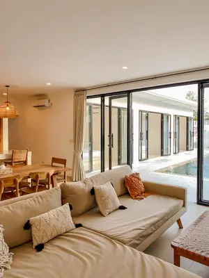 a living room with a couch and a table at Villa Balibiza 3 Kerobokan in Seminyak