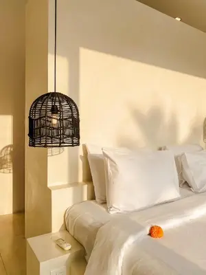 a bedroom with a white bed with a bird cage on it at Villa Balibiza 3 Kerobokan in Seminyak
