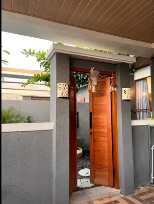 a front door of a house with a door open at Villa Teras Asri Seminyak in Denpasar