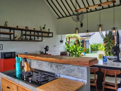 a kitchen with a stove and a counter top at Mistral Studio Umalas in Canggu