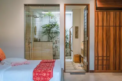 a bedroom with a bed and a sliding glass door at PROMO - 4 Bedroom Designer Villa 2 minutes to Berawa Beach & Finns in Canggu