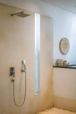 a shower in a bathroom with a glass door at PROMO - 4 Bedroom Designer Villa 2 minutes to Berawa Beach & Finns in Canggu